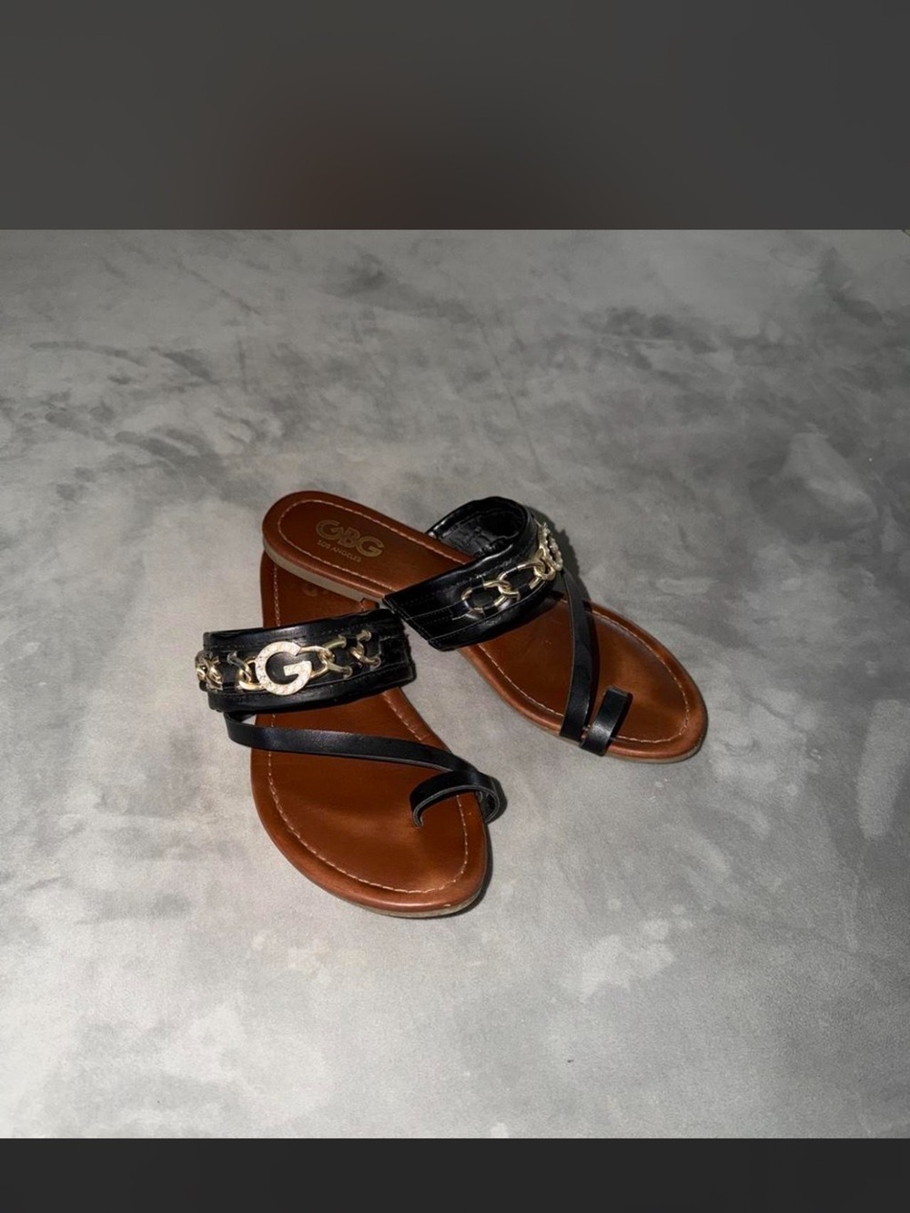 G by Guess Black Leather Toe-Loop Sandals with Gold Chain Accent